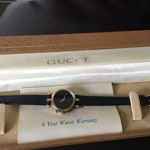 Black and gold Gucci woman’s watch